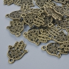 Schmuckzubehör Anhänger 'Hamsa', Durchmesser 21×15 mm, Lochdurchmesser 1,7 mm, Verpackung 24 Stk ±, bronzefarbenes Metall